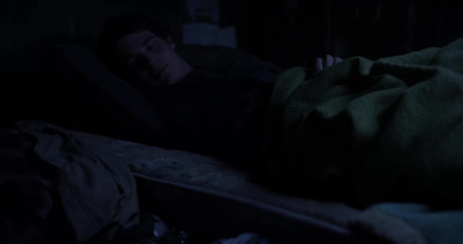A man sits up from bed