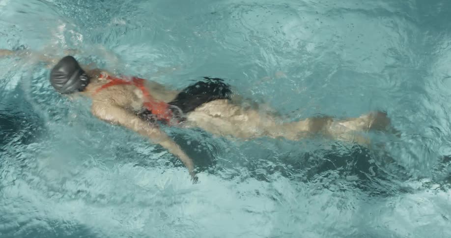 Woman swims in a swimming pool