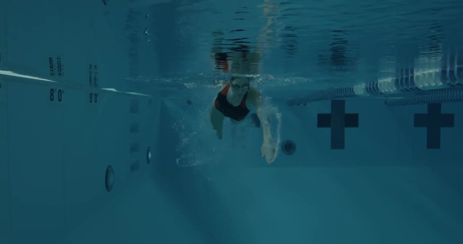 A swimmer dives into a pool