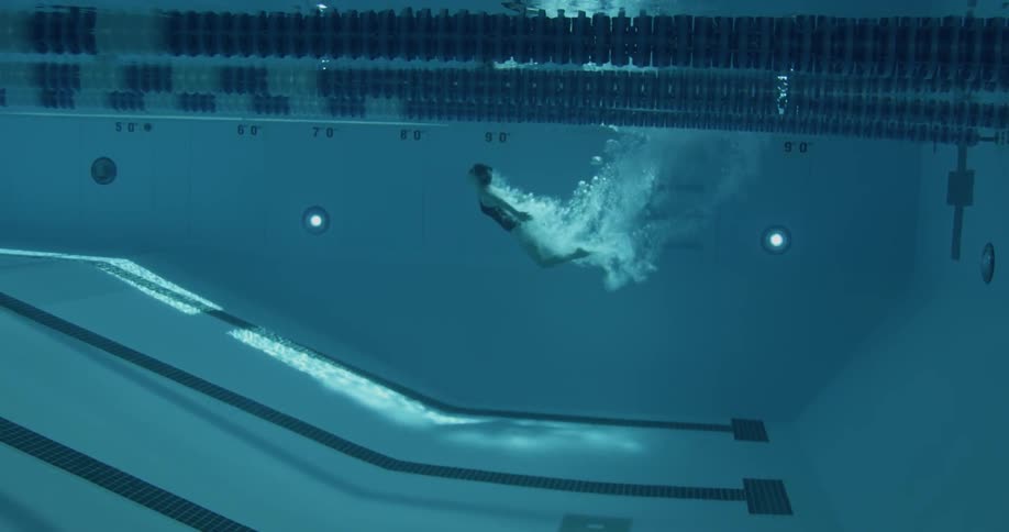 Woman dives into swimming pool
