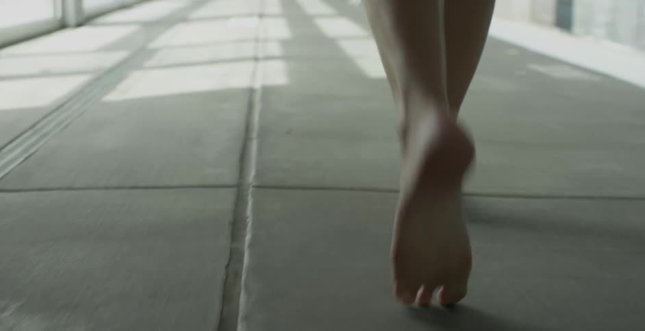 Woman walks barefoot on the pavement