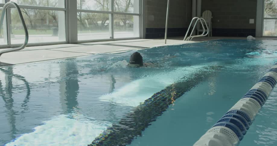Woman swims in an indoor pool