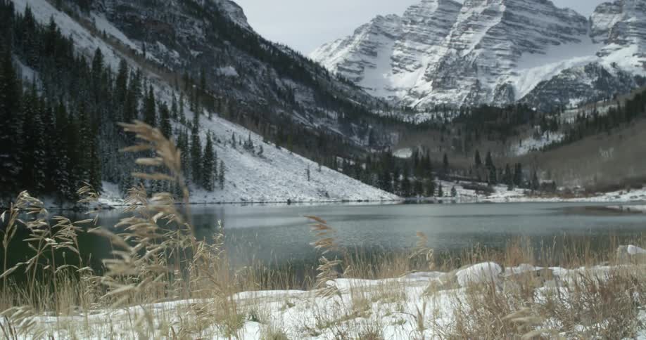 The snow has fallen gently around this hillside lake