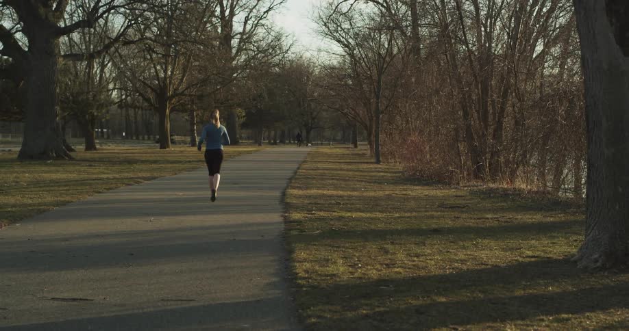A woman is jogging alone