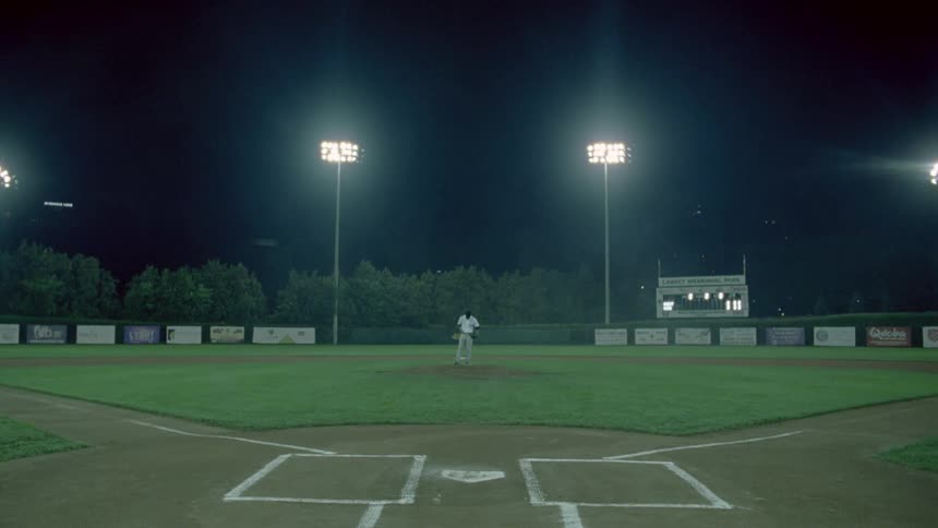 A pitcher climbs the mound ready to throw out the ball