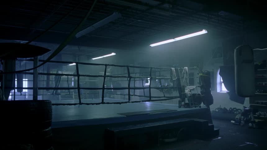 A boxing ring in an empty gym
