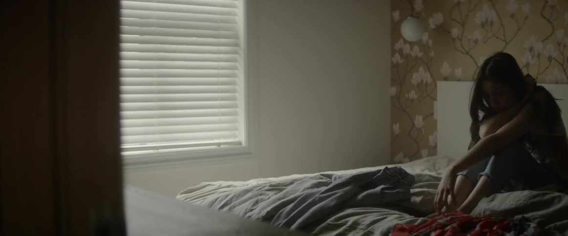 A woman sits in bed