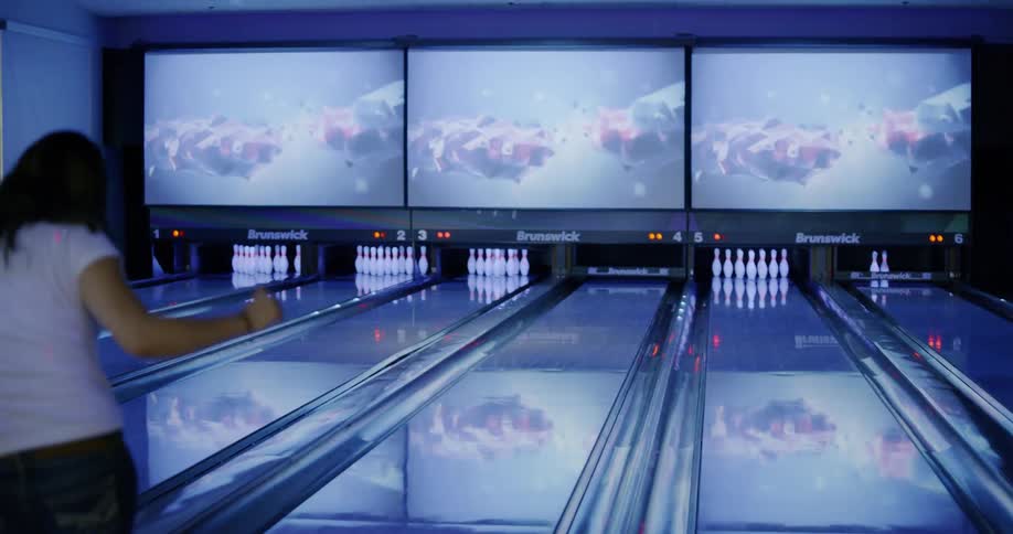 A woman celebrates after she knocks down a spare while bowling
