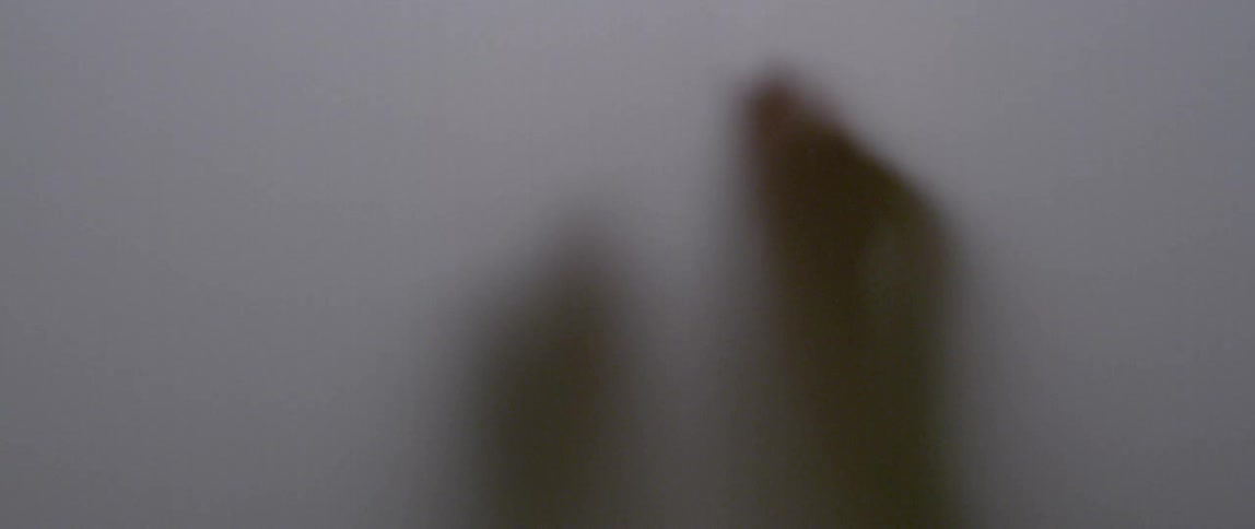 Hands against a translucent cloth