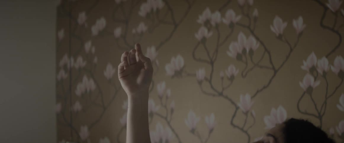 A woman is holding her arm in the air and twisting it around