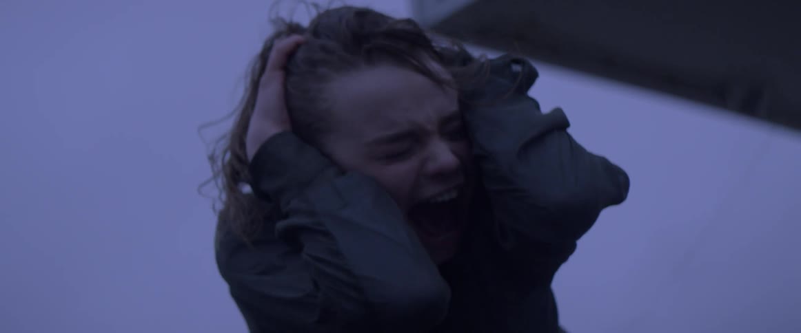 Woman screams while grabbing her head