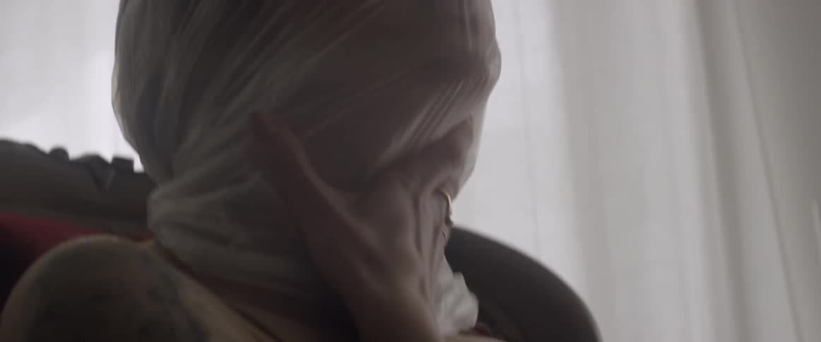 A woman has a plastic bag over her head and she is panicking
