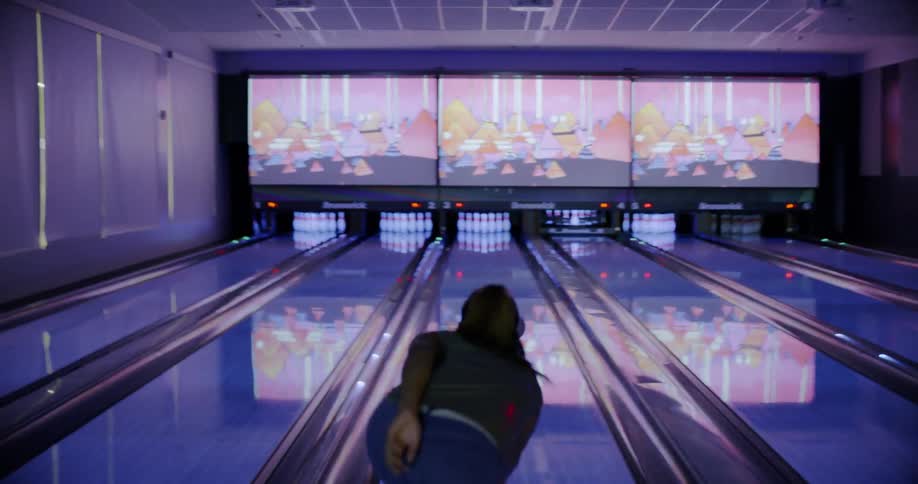 Woman bowls a strike