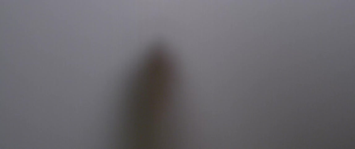Hand behind a white screen