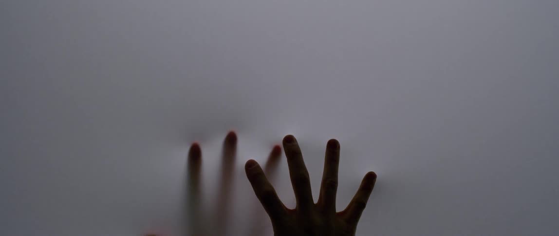 Two hands rub against the white screen poking slowly