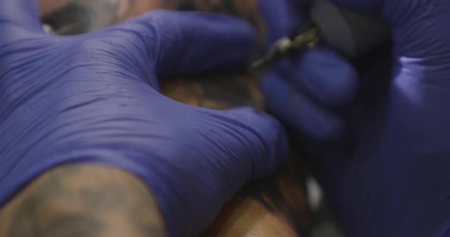 A man is giving a tattoo