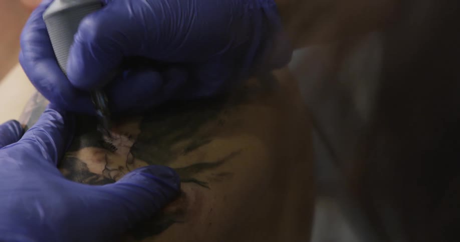 Person getting a large tattoo on their shoulder