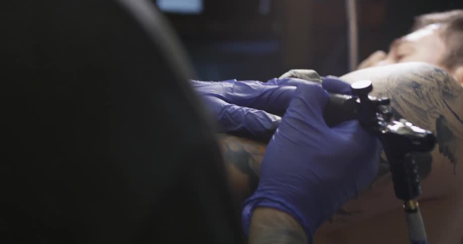 Man getting his body tattooed