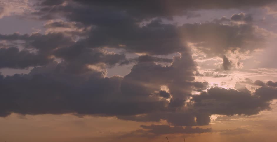 The crimson sky has the sun setting behind the clouds