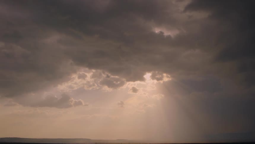 The sun shining through clouds