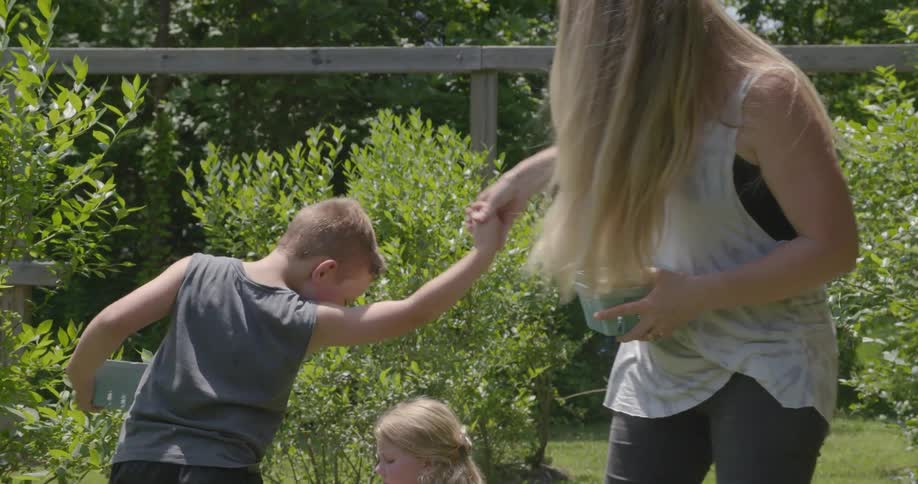 A woman dancing with her child in the garden