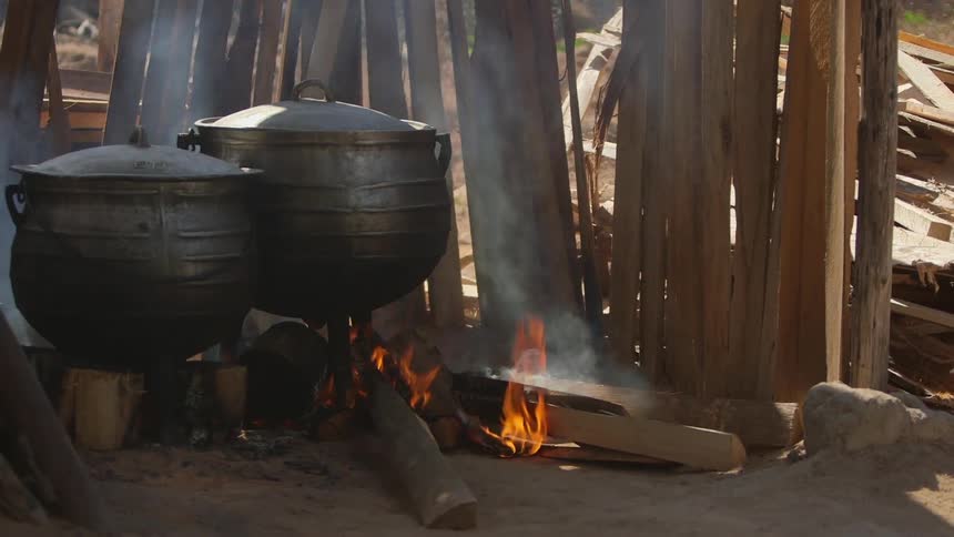 Pots cooking on a fire