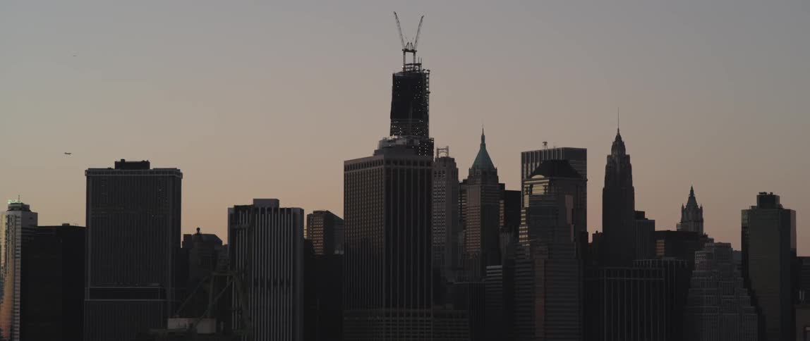 A city is shown at dusk