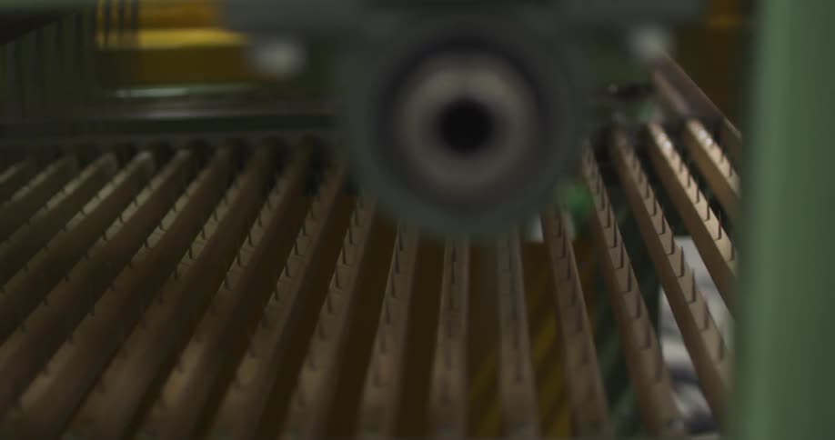 A machine working on items on a conveyor belt