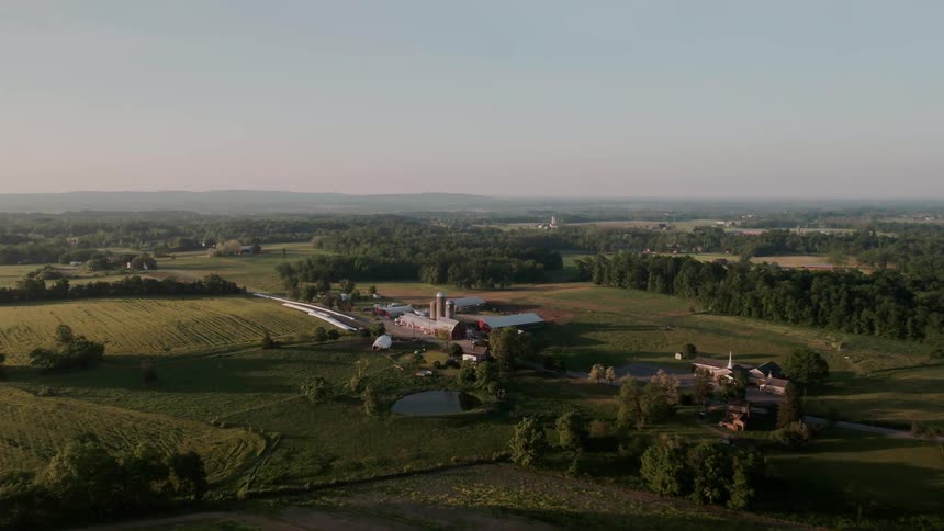 Silos stand next to a barn