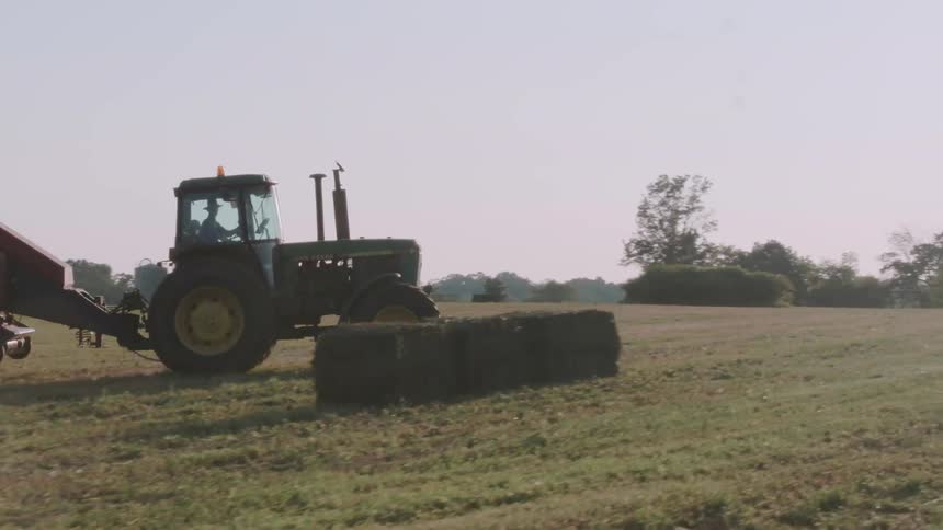 A tractor drives through farmland