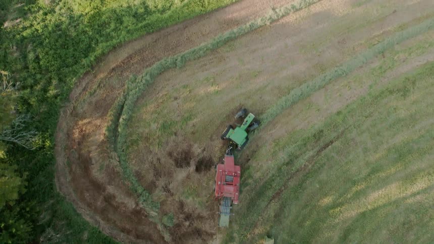 A tractor is pulling around a piece of machinery