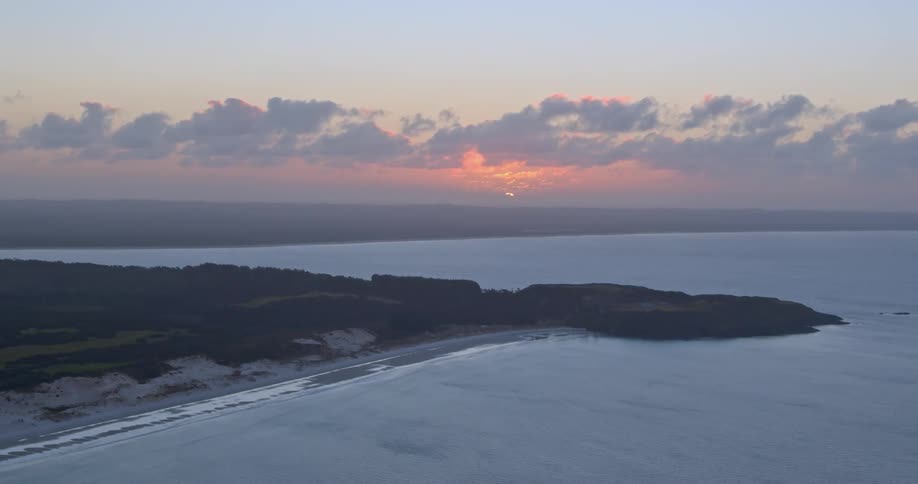 The sun sets over the ocean
