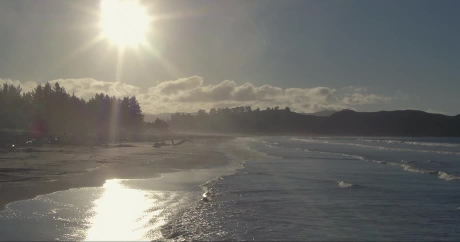 Small waves are crashing along a beach shore
