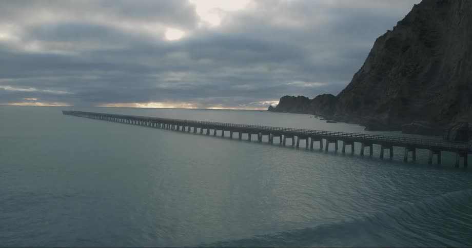 Waves roll past a pier