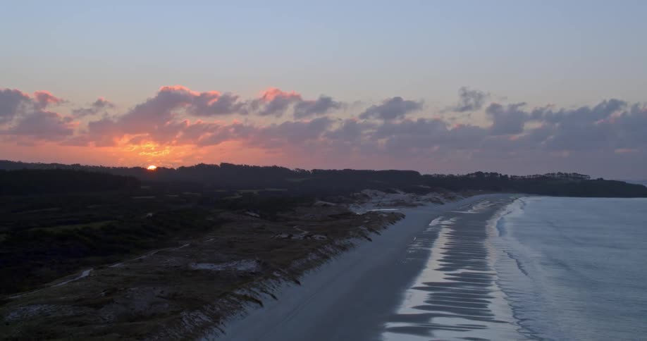 Waves flow onto the beach shore