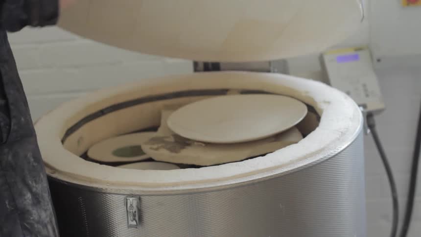 A person opening a lid