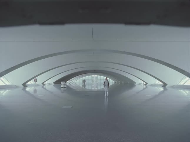 A person walks in a modern white building