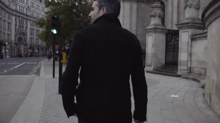 Man walks on a city sidewalk