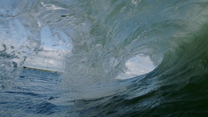 A large wave crashes spinning water everywhere