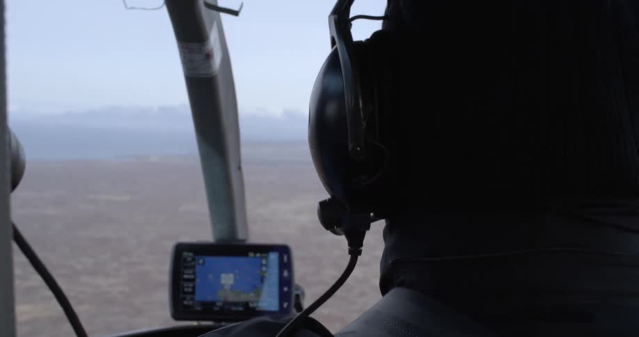 A pilot is flying over a field