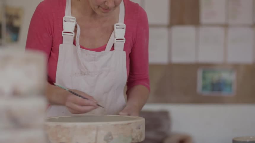 A woman is making a cake by herself
