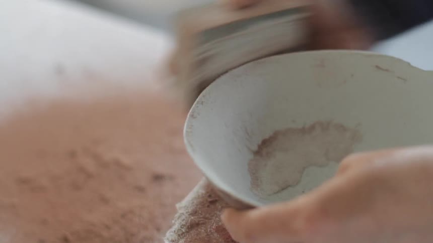 A woman is making a bowl
