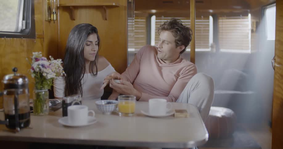 A man and woman play with cards at a table