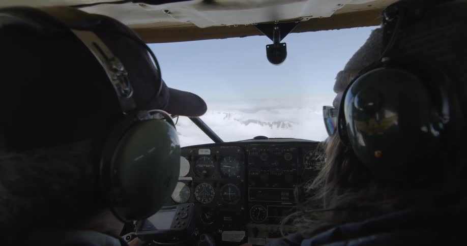 Two people flying a small aircraft