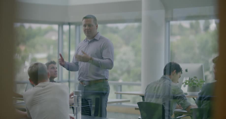 A teacher is giving a lecture in a classroom