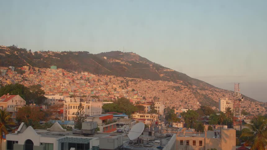 The sun shines on the side of a mountain town