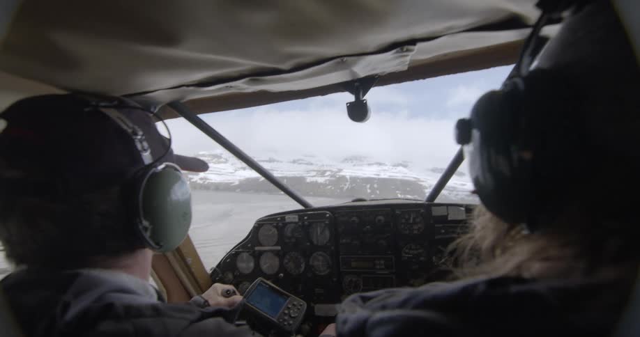Two people flying in a small plane