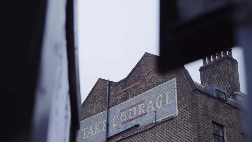 Building with a large sign on it on an overcast day