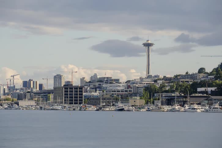 Boats travel in the waterway next to a city