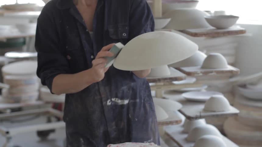 A woman is making bowls